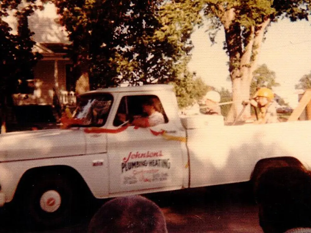 Johnson's Plumbing - Historic Photo of Eldon Johnson driving original plumbing truck
